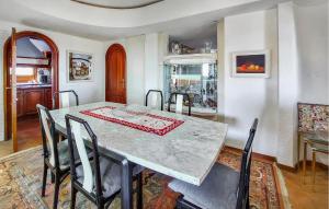 a dining room with a table and chairs at Beach Front Home In Vinaroz in Vinaròs