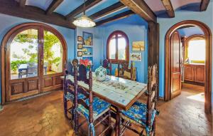 a dining room with blue walls and a table and chairs at Beach Front Home In Vinaroz in Vinaròs