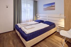 Postel nebo postele na pokoji v ubytování De Pelikaan Texel Appartementen