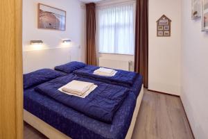 Postel nebo postele na pokoji v ubytování De Pelikaan Texel Appartementen