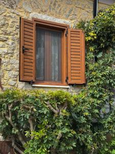 a window on the side of a stone building at Villa Eva's in Himare