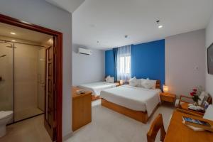 a hotel room with two beds and a bathroom at Stellar Phú Quốc - Hotel in Phu Quoc +43 photos