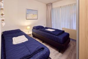 Postel nebo postele na pokoji v ubytování De Pelikaan Texel Appartementen