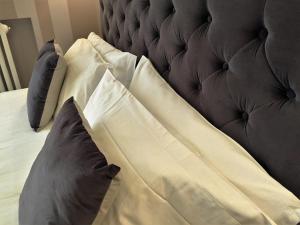a white pillow on top of a white couch at 29 Venti Luxury in Palermo