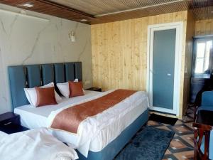 a bedroom with two beds in a room at Silver Dew Resorts and Restaurant in Dhanaulti