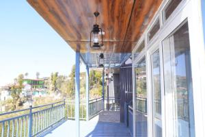 a balcony of a house with a view at Silver Dew Resorts and Restaurant in Dhanaulti