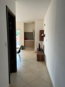 a living room with a table and a kitchen at Apartments Maria & Marta in Seline