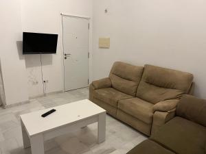 a living room with a couch and a coffee table at Vente pa Jere in Jerez de la Frontera +6 photos