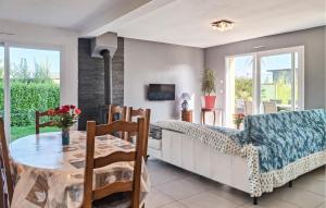 a living room with a table and a couch at 3 Bedroom Lovely Home In Saint-Pabu in Saint-Pabu