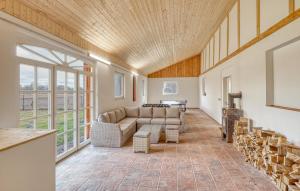 a living room with a couch and a table at 3 Bedroom Stunning Home In Sittensen Kalbe in Kalbe +32 photos
