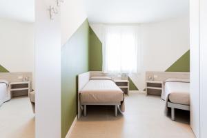 a hospital room with two beds and a window at Tivoli in Bibione +149 photos