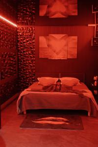 a bedroom with a bed with red walls at L'étincelle in Saint-Christol-lès-Alès