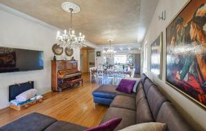 a living room with a couch and a piano at Luxurious Home In Gianico in Artogne