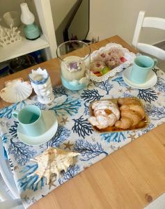 a table with a table cloth with pastries on it at La Casa del mare in Syracuse +14 photos