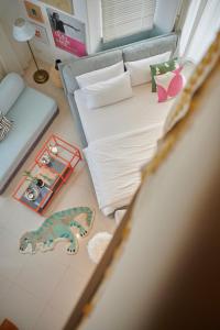 a bedroom with a bed with a dinosaur on the floor at Casapapa Home&Space in Talat Amphoe Nakhon Chai Si +77 photos