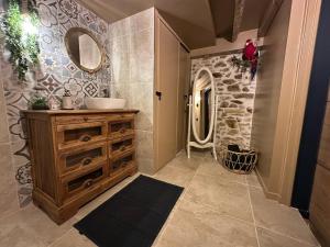 a bathroom with a sink and a vanity and a mirror at Le trésor des Caraïbes in Bussy-Saint-Georges +12 photos