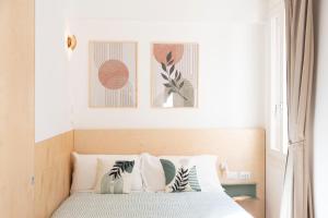 a bedroom with a bed with three pictures on the wall at Hinc Domus - Venezia Historical City Center in Venice +179 photos