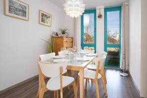 a dining room with a table and chairs and a window at Ferienwohnung Meeresbrise in Binz +8 photos