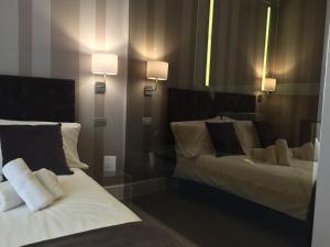 a hotel room with a bed and a lamp at 29 Venti Luxury in Palermo
