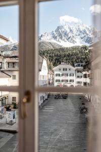 a view from a window of a courtyard with mountains at Boutique & Gourmet Hotel Orso Grigio - Grauer Bär in San Candido +116 photos