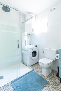 a bathroom with a toilet and a washing machine at Rodas Apartment in Torrevieja +43 photos