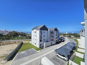 an apartment building with a car parked in front of it at Bella Mare 12 on Second in Gqeberha