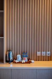 a wooden shelf with food and water bottles on it at Bintang Bungalow in Nusa Penida