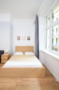 a bed in a white room with a window at Pillow Heaven King BB in Budapest
