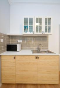 a kitchen with a sink and a microwave at Pillow Heaven King BB in Budapest +8 photos