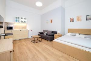 a bedroom with a large bed and a couch at Pillow Heaven King BB in Budapest