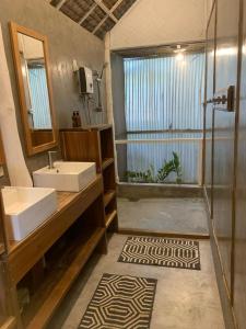 a bathroom with a sink and a shower at Lugadia Bungalow in El Nido