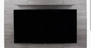 a flat screen tv sitting on top of a fireplace at Laertis Studio in Kattavía