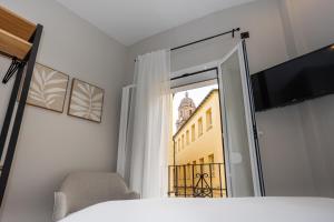 Televízia a/alebo spoločenská miestnosť v ubytovaní Chinitas Urban Rooms