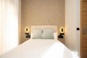 Posteľ alebo postele v izbe v ubytovaní Chinitas Urban Rooms
