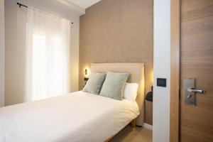 Posteľ alebo postele v izbe v ubytovaní Chinitas Urban Rooms