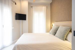 Posteľ alebo postele v izbe v ubytovaní Chinitas Urban Rooms
