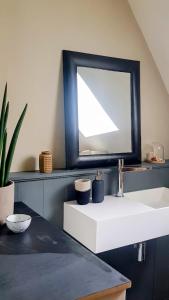 a bathroom with a sink and a mirror at la maison haute in Toucy +8 photos