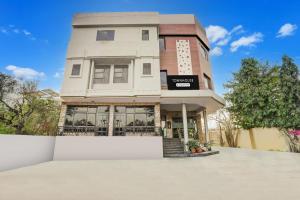 a building with a sign on the side of it at Super Townhouse Sikar Road Jaipur Formerly Hotel Aroma Inn in Jaipur