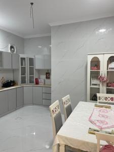 a kitchen with a table and chairs and a table and a kitchen at نسيم سلطانة in Al Madinah
