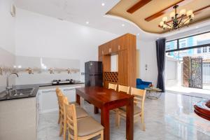 a kitchen with a wooden dining table and chairs at Homestay 59-38 Phan Chu Trinh, Bãi Sau in Vung Tau +34 photos