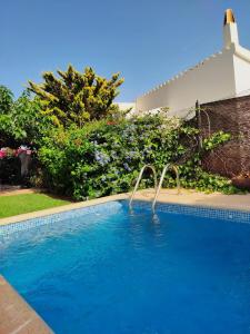 a swimming pool with a water slide in a yard at Clarona in Cala en Blanes
