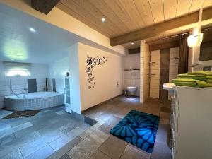 a large bathroom with a tub and a shower at Ferienhaus Jeppe Hus Humptrup in Humptrup