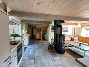 a kitchen and living room with a stove at Ferienhaus Jeppe Hus Humptrup in Humptrup