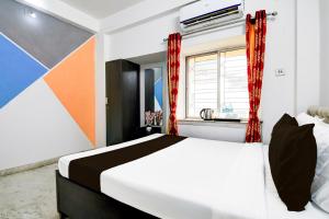 Ένα ή περισσότερα κρεβάτια σε δωμάτιο στο Hotel O Anandapur Near Annapurna Garden +21 φωτογραφίες