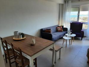 a living room with a table and a couch at La Manga beach has everything in San Javier