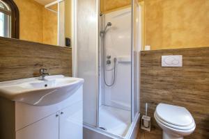 a bathroom with a shower and a sink and a toilet at Villa Luna e' Pedra - Suites Esclusive in Villa con Vista sulla Baia di Alghero e Piscina, Jacuzzi privata in Alghero +43 photos