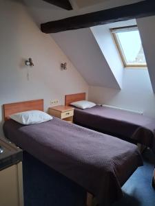 Postel nebo postele na pokoji v ubytování Hommiku Guesthouse