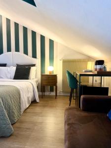 a bedroom with a bed and a table with a desk at Palazzina300 in Treviso