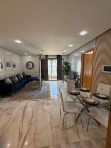 a living room with a couch and a table and chairs at Very beautiful apartment with see view 5th in Casablanca