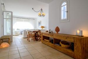 a living room with a table and a dining room at Soho Villa in Paros in Chrissi Akti